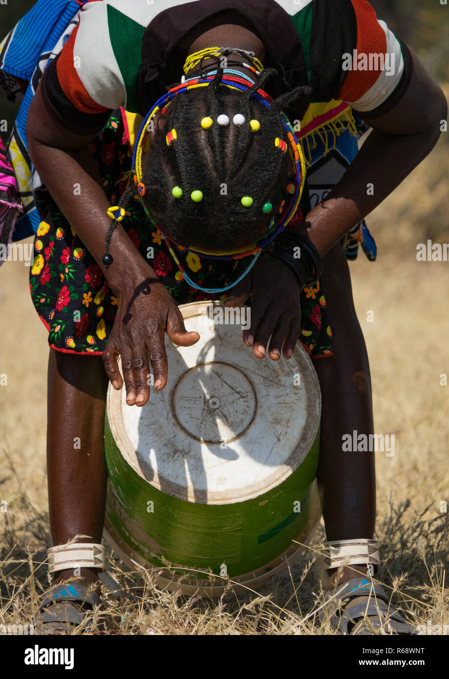 Tribù Mudimba donna di riproduzione di musica con una benna, Provincia del Cunene, Cahama, Angola Foto Stock