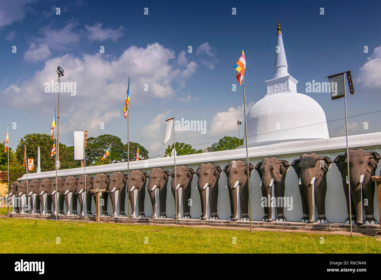 Una linea chiusa di elefanti scolpiti proteggere il Ruwanwelisaya Stupa in città sacra di Anuradhapura in Sri Lanka Foto Stock