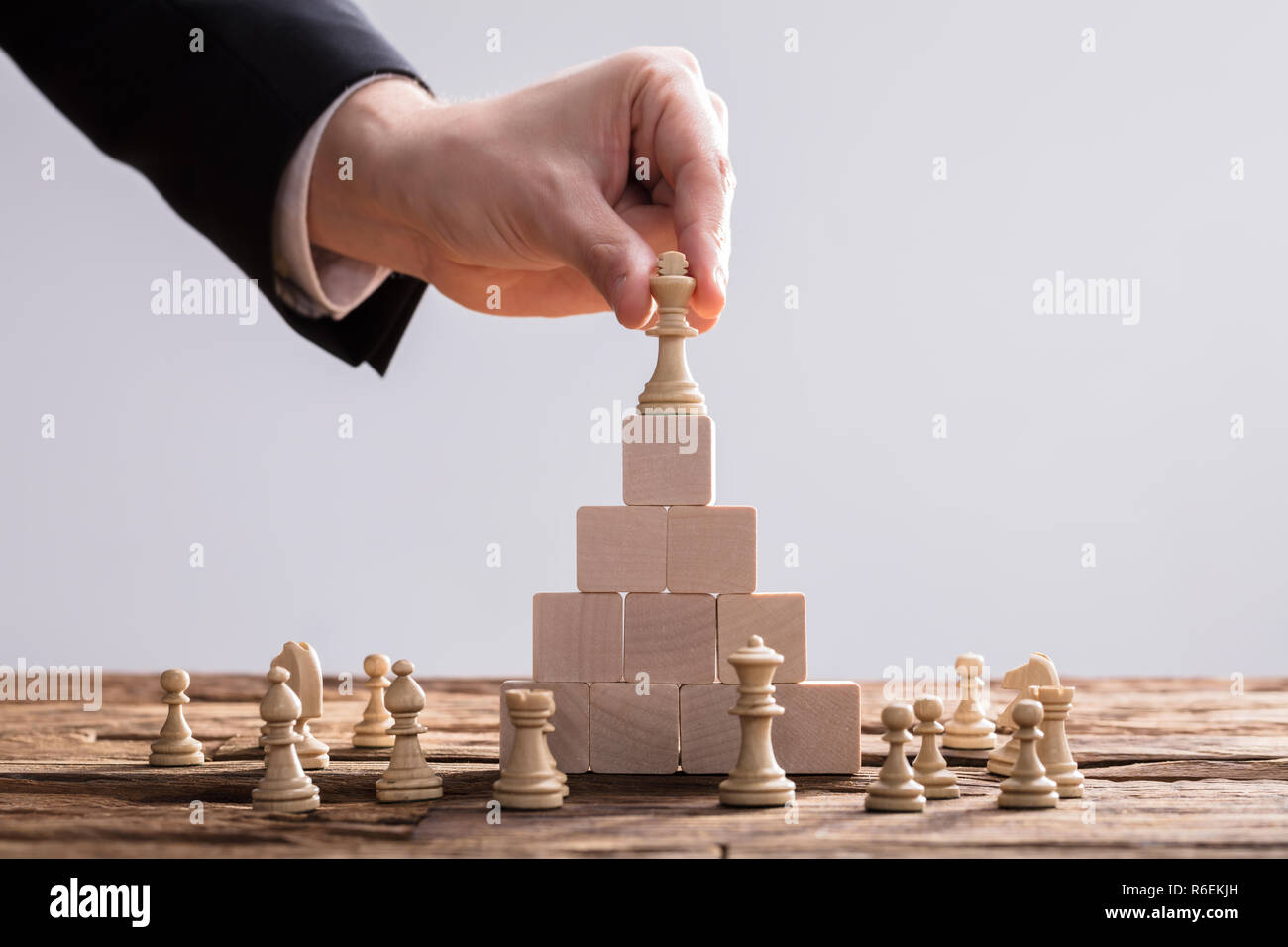 I mediatori immissione re pezzo degli scacchi sulla parte superiore dei blocchi di legno Foto Stock