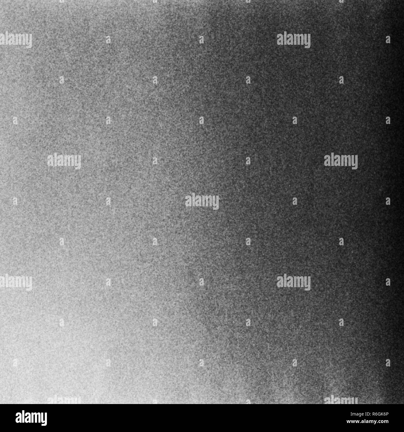 Bianco e nero testurizzato sfondo con perdite della luce e la granella Foto Stock