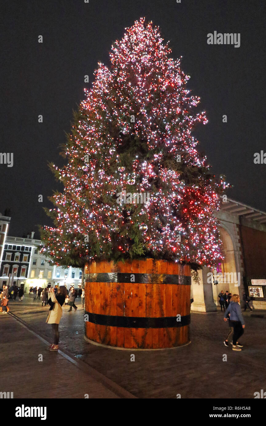Un enorme albero di Natale visto intorno a Londra il mercato di Covent Garden e piazza. Foto Stock
