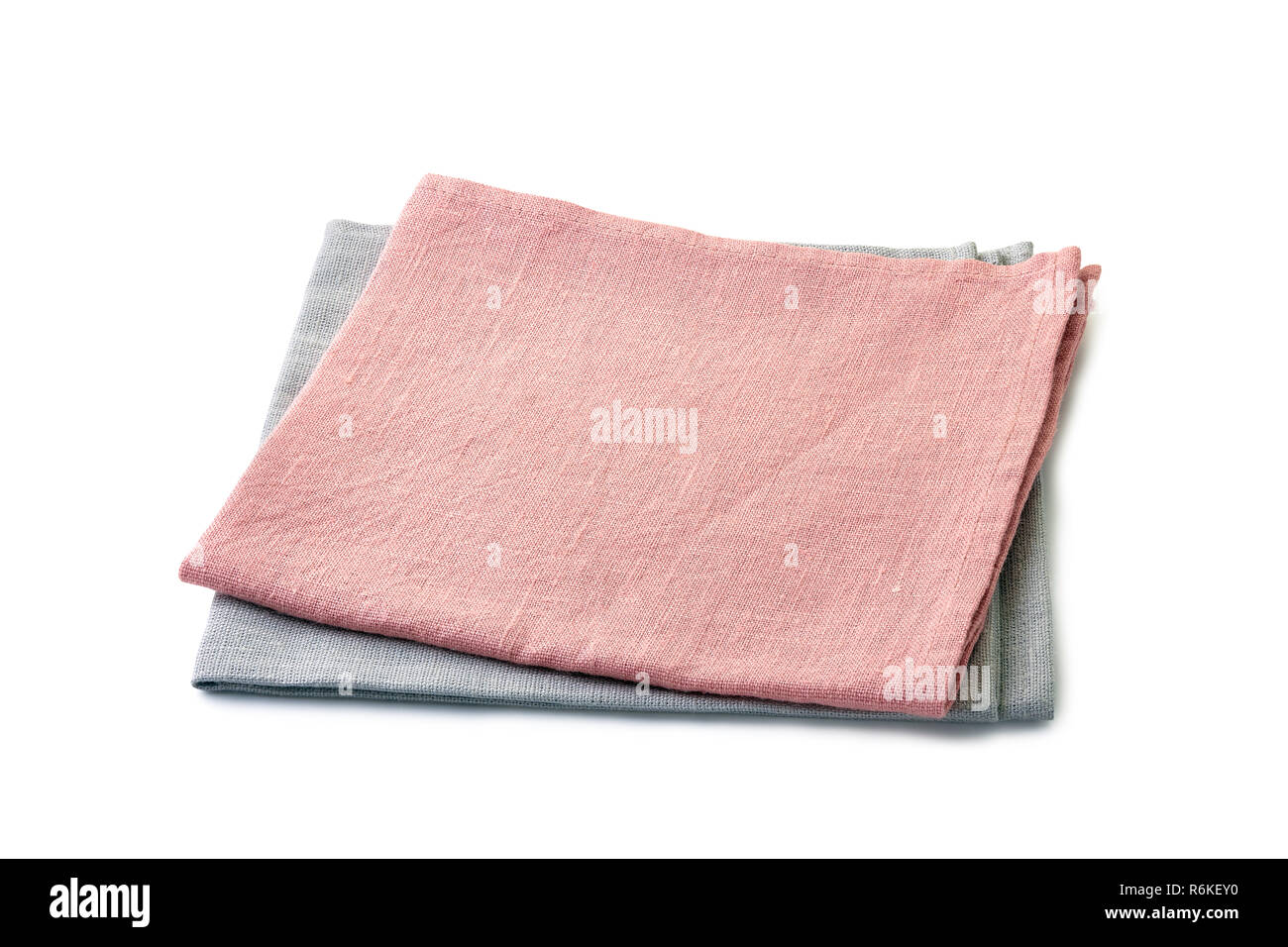 Ripiegate rosa chiaro e grigio pallido tovaglioli impilate su bianco Foto Stock