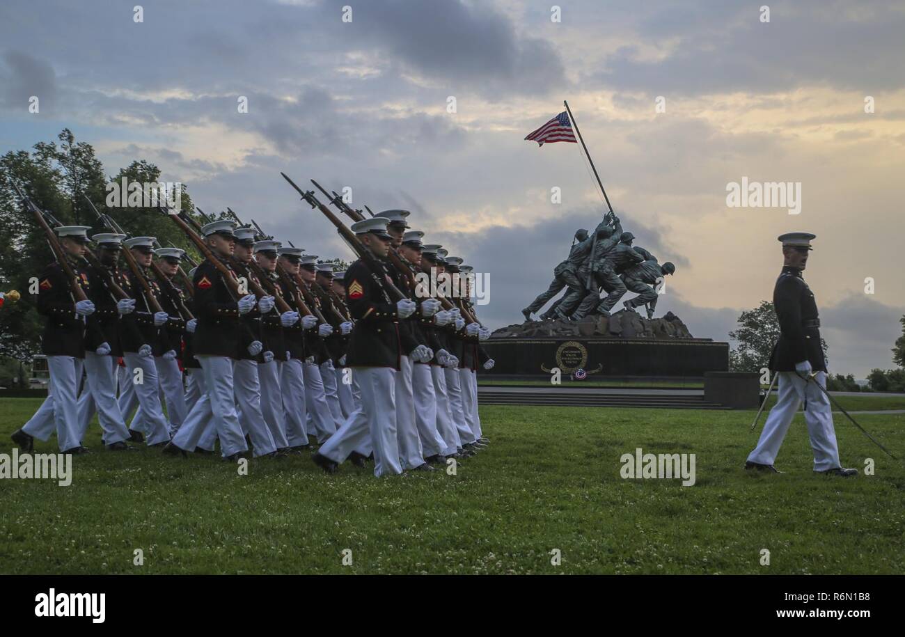 Società di Marching Band con Marine Caserma Washington D.C. eseguire passare in rassegna durante un martedì tramonto Parade presso il Marine Corps War Memorial, Arlington, Virginia, 30 maggio 2017. Ospiti d'onore per la parata erano il sig. Bruce Rose, fondatore e CEO della società Carrington, e il Sig. Walter Fricke, fondatore, presidente e CEO di veterani comando Airlift. L hosting ufficiale è stato Lt. Gen. Ronald Bailey, vice comandante, piani, politiche e operazioni. Foto Stock