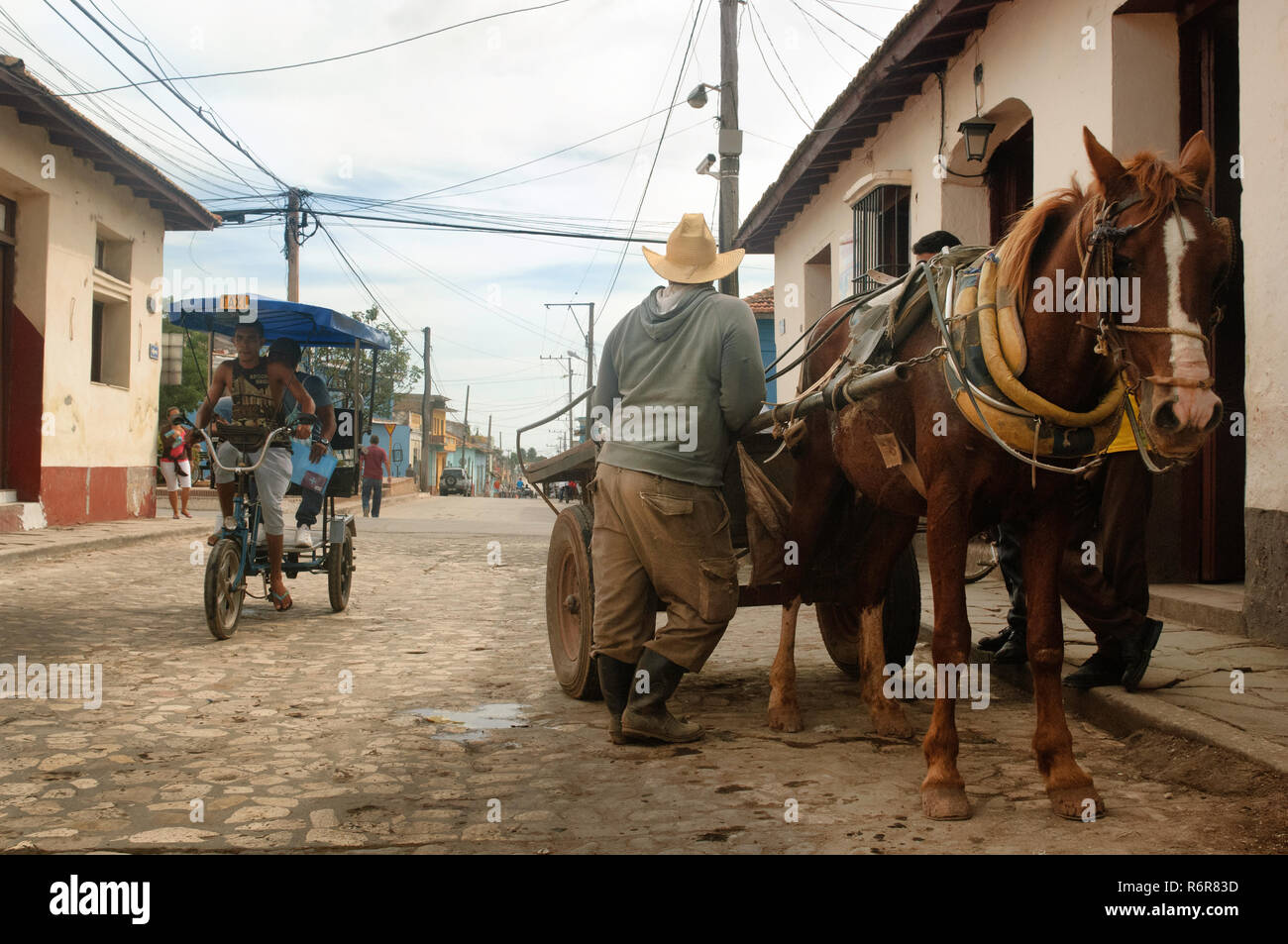 Cavallo con carrello e bici taxi in attesa di clienti per le strade di Trinidad, Cuba. Foto Stock