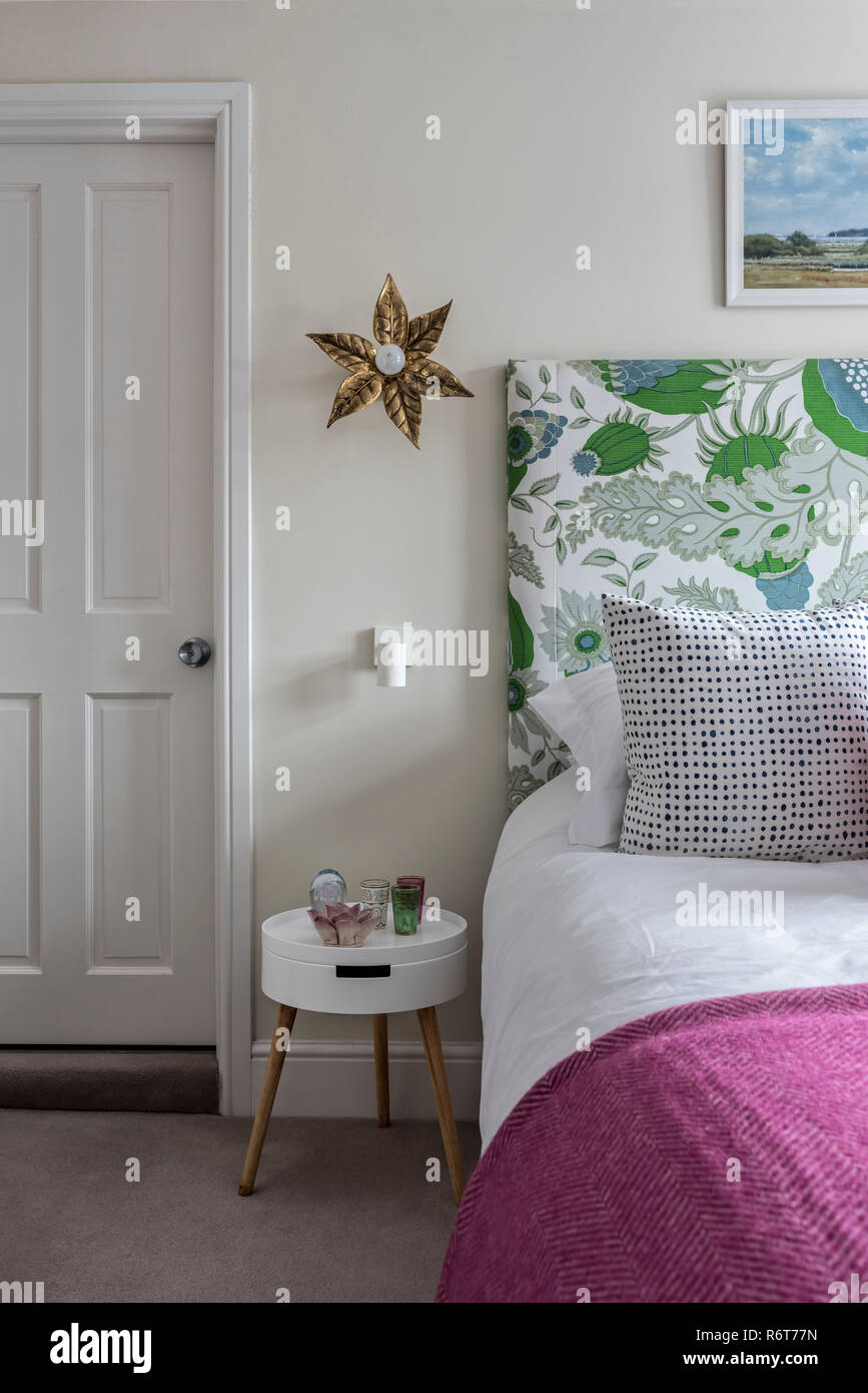 Il carnevale tessuto da Christopher Farr con il Design Vintage comodino e luce da parete da Graham & verde. Foto Stock