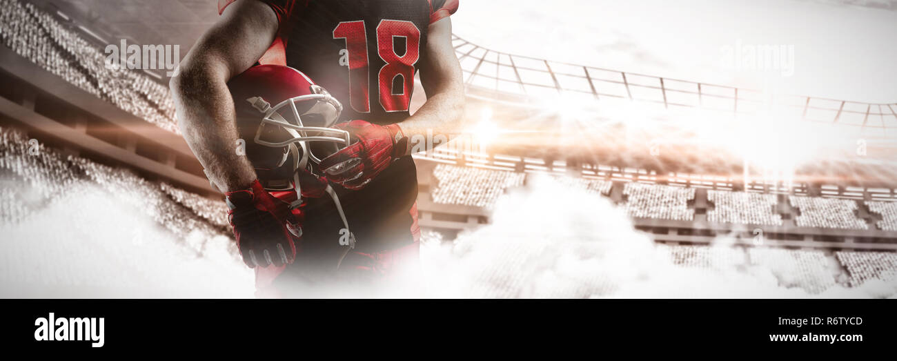 Giocatore di football americano in piedi con casco Foto Stock