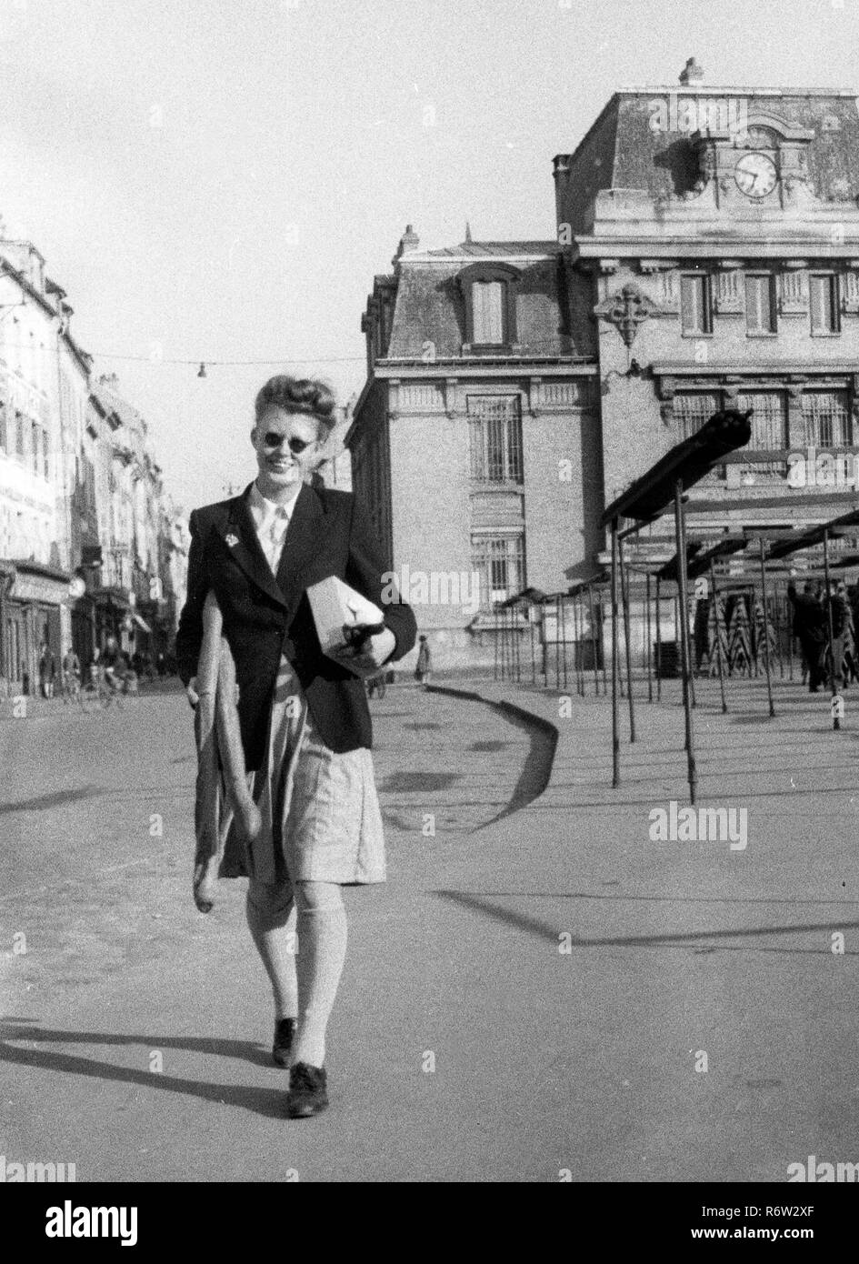Parigi Francia aprile 1944 donna shopping con baguette di pane. Parigi Francia francese 1940 femminile tempo di guerra occupato Foto Stock