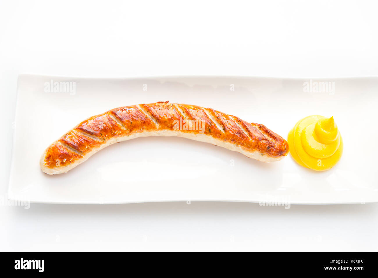 Il bratwurst con senape e pane Foto Stock