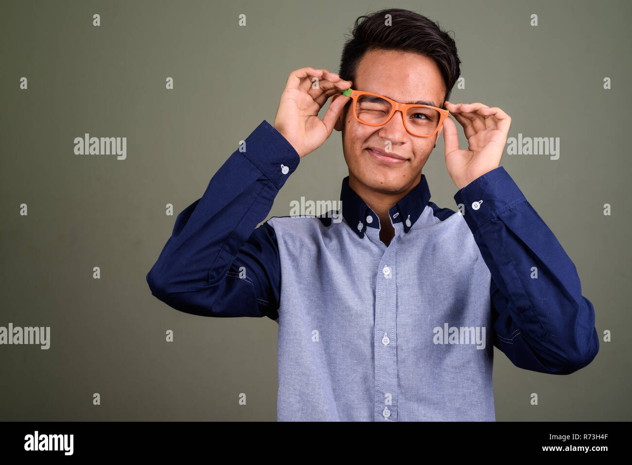 Giovani indiani handsome man looking smart contro backgrou colorati Foto Stock