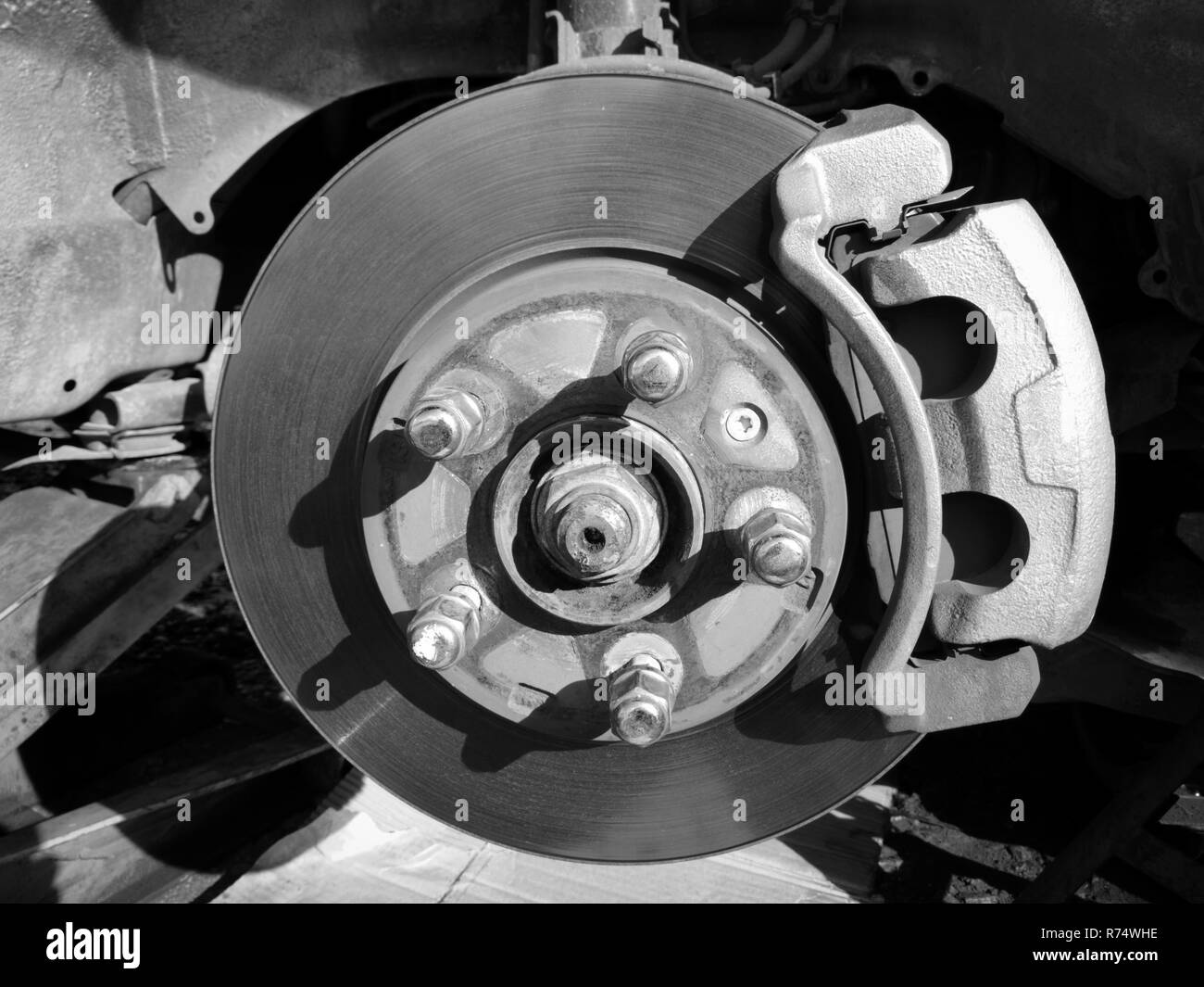 I freni a disco auto / modifica del freno di nuovo sui freni a disco rimuovere la ruota auto per riparazione in auto di servizio monocromatico Foto Stock