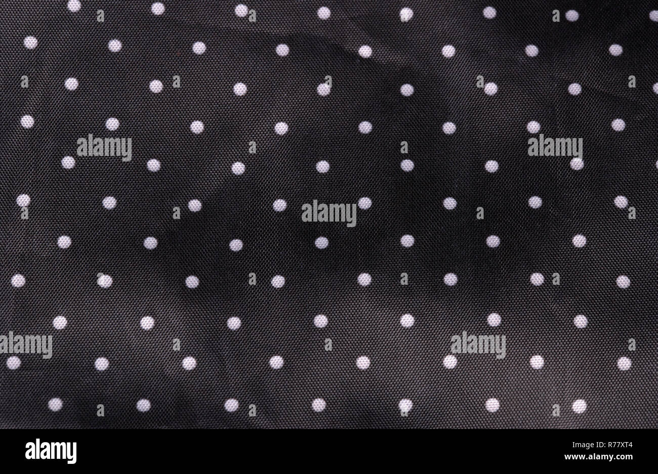 Tessuto nero lo sfondo con puntini bianchi Foto Stock