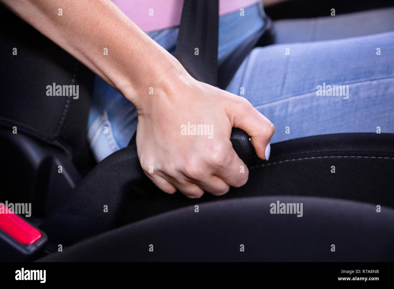 Close-up di una donna la mano tirando il freno a mano di un automobile Foto Stock