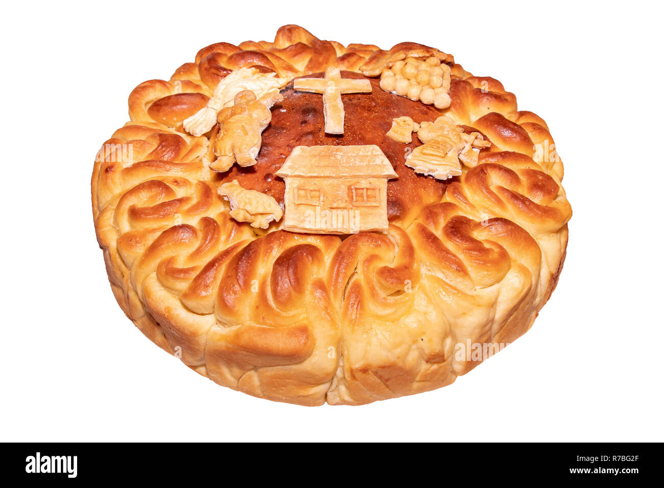 Il pane fatto in casa korovai per vacanze e matrimoni sul tavolo tra i popoli slavi su sfondo bianco Foto Stock