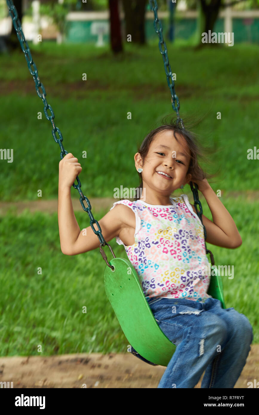 Ragazza asiatica basculante e sorridente. Filipina kid. 7 anni di età. Foto Stock