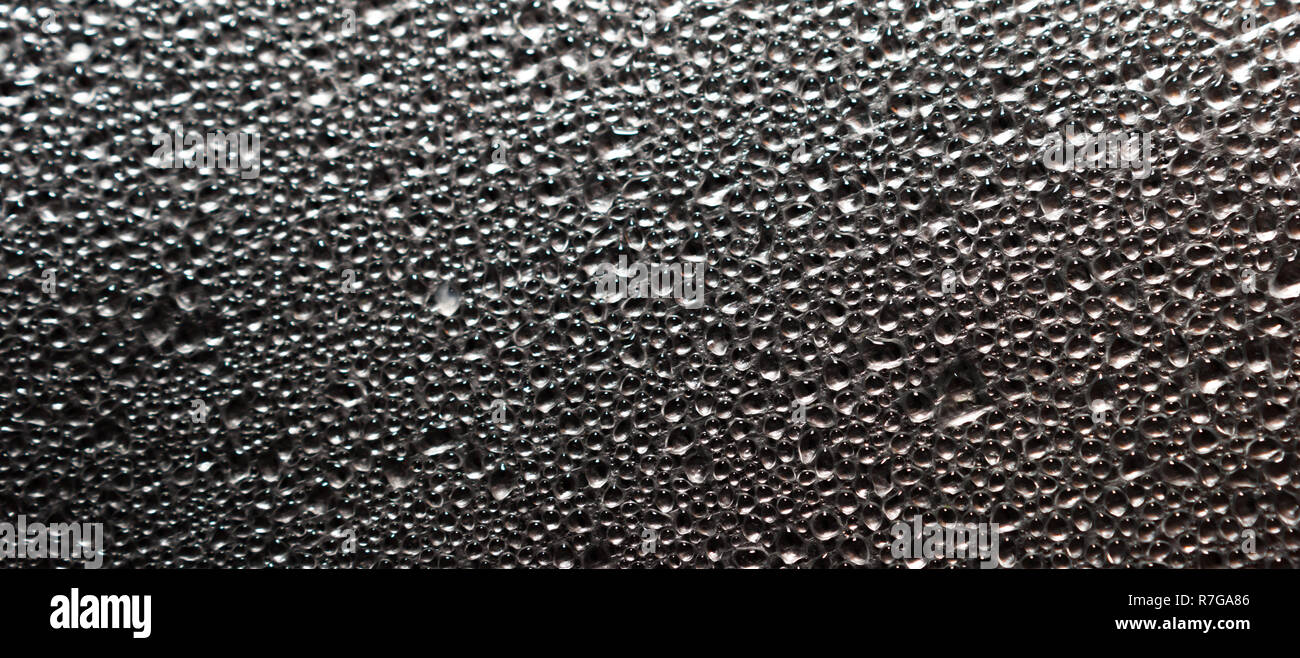 Sfondo astratto di vapore umido o goccioline di acqua sulla lamina di alluminio superficie. Macro vista dall'alto. Foto Stock
