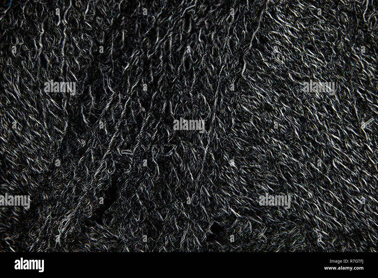 Nero lana FILI BOBINATI closeup, incandescente monocromatico sfondo astratto o texture Foto Stock