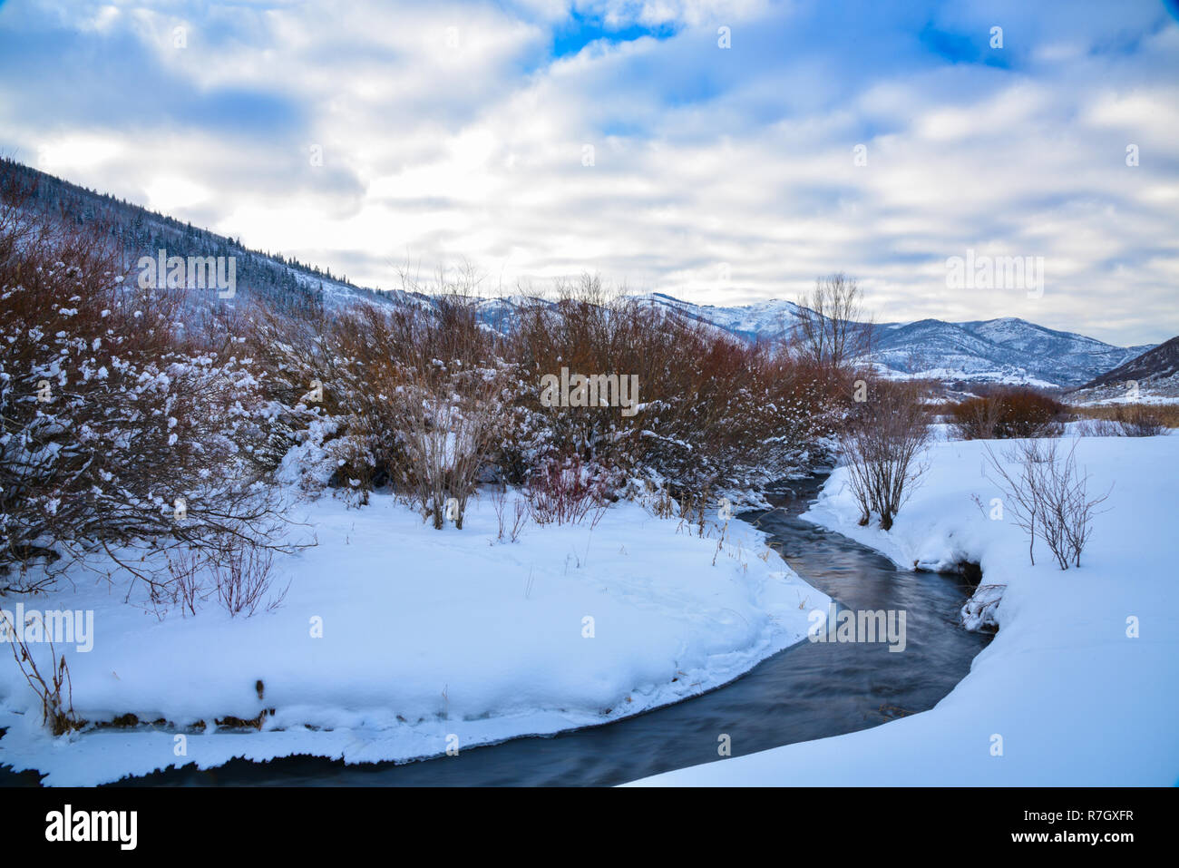 Un piccolo ruscello che scorre attraverso un prato nevoso vicino a Park City, UT. Foto Stock