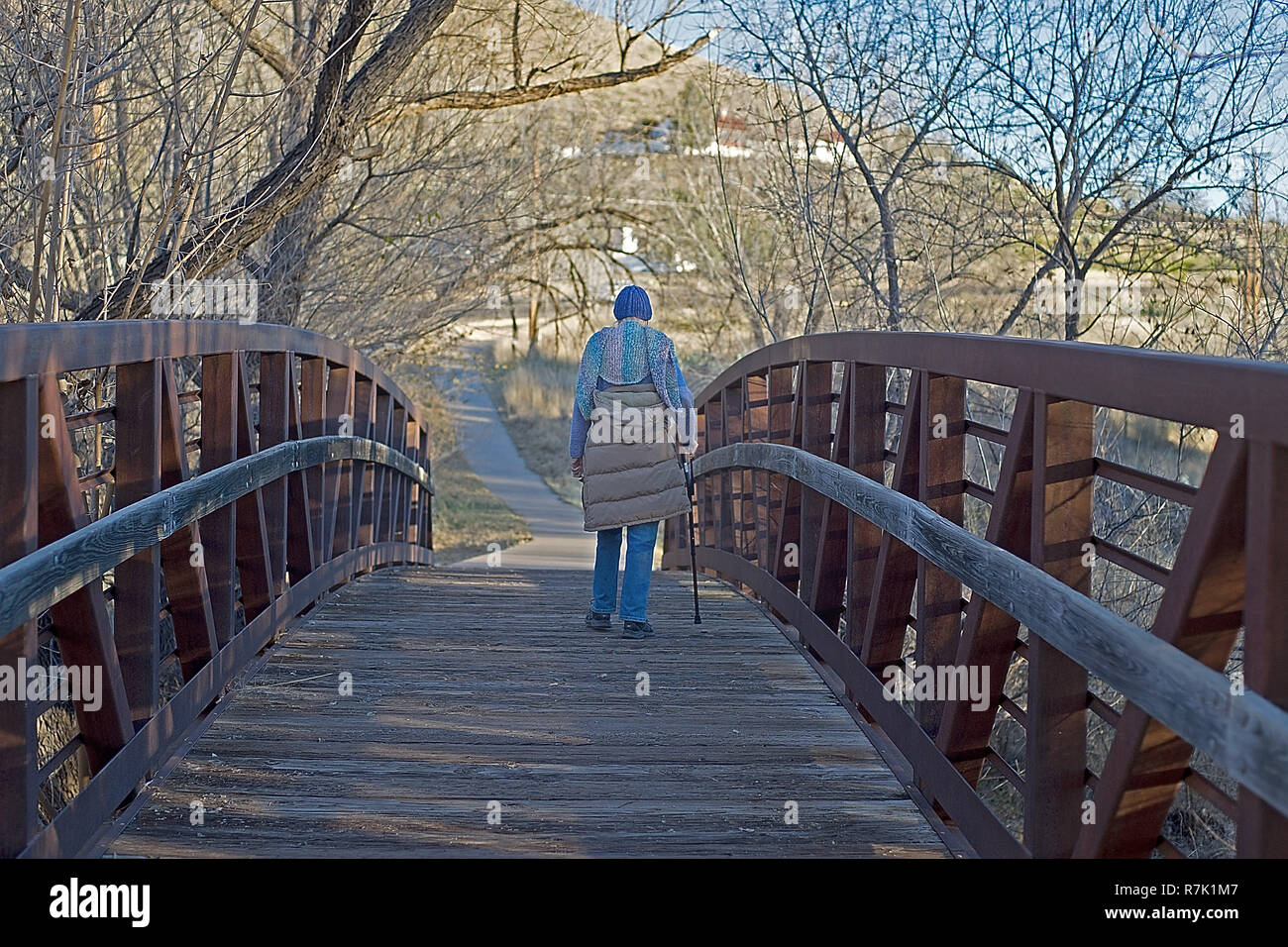 Donna anziana camminando in un parco pubblico. Foto Stock
