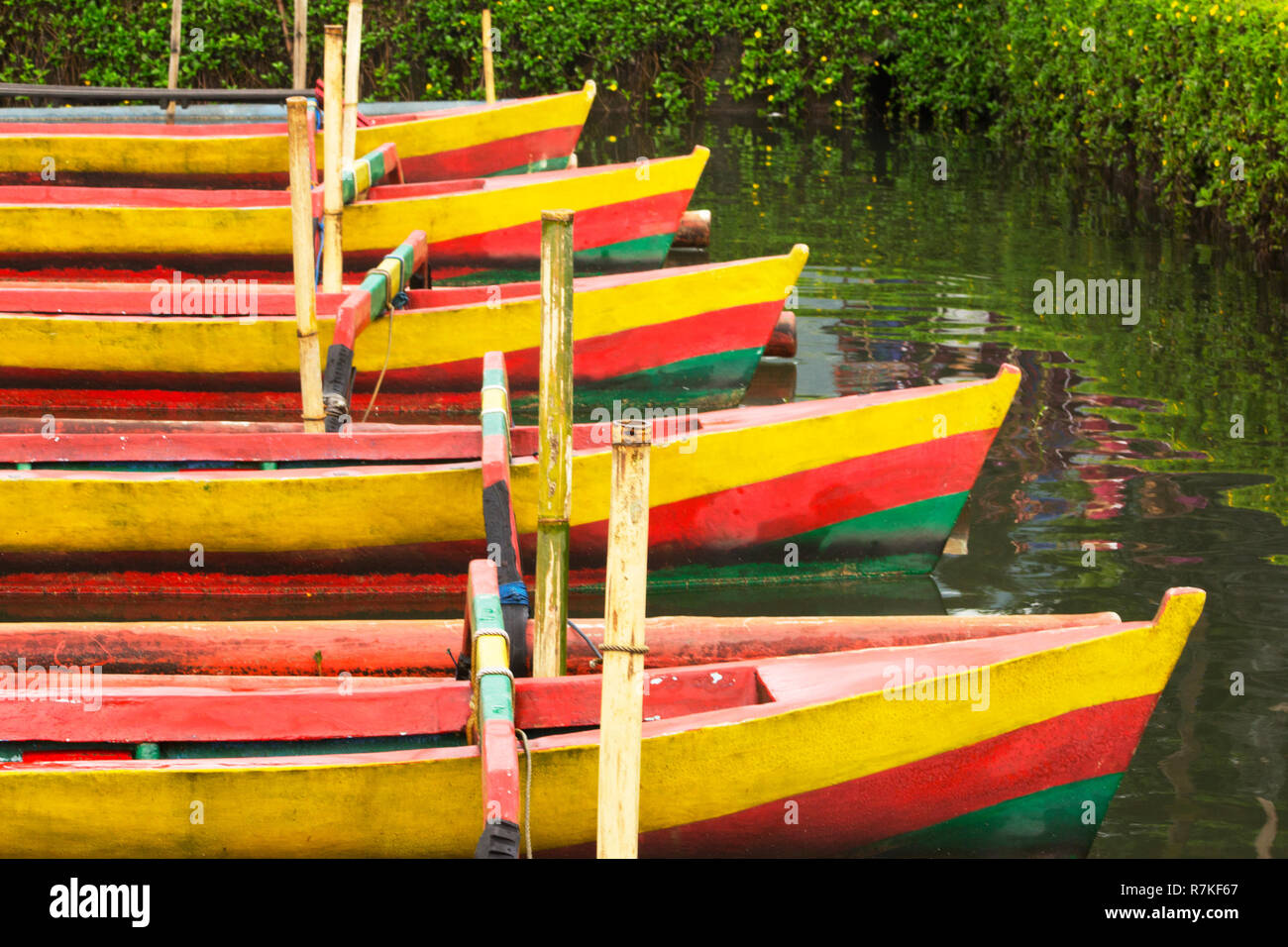 Vivacemente colorato stile Balinese tradizionale canoe di legno in un lago Foto Stock