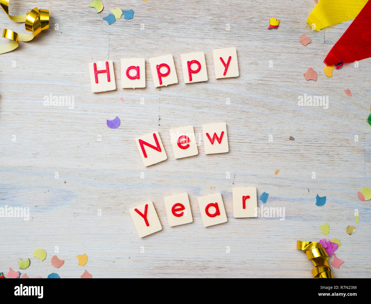 Felice anno nuovo in lettere rosse con party decorazione su sfondo di legno, il concetto di immagine Foto Stock