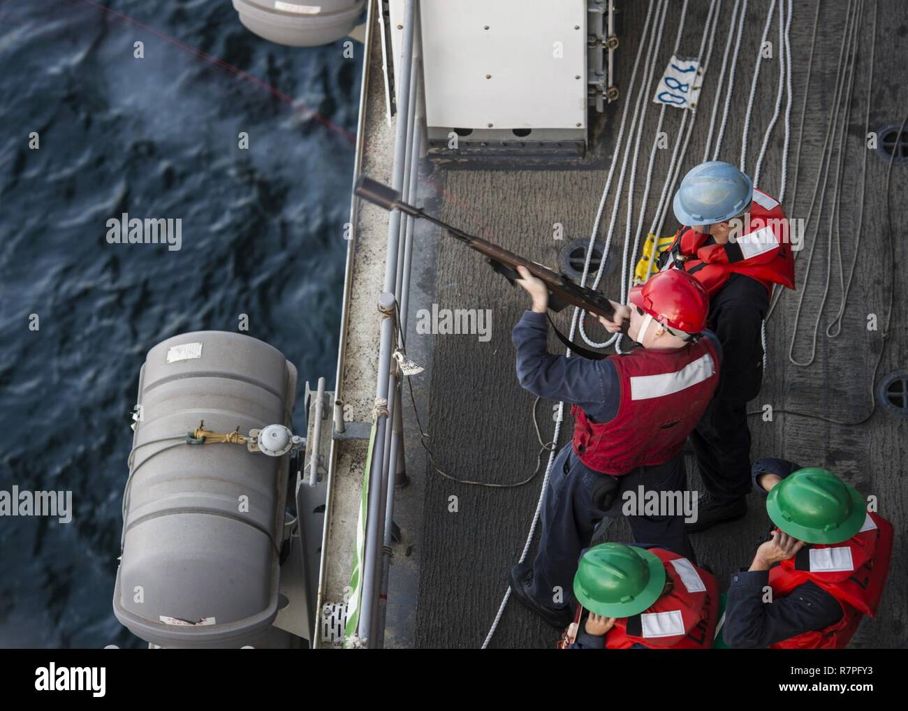 Mare Arabico (23 marzo 2017) da bombardieri Mate 2a classe Derek Smith, da Grand Junction, Colo., spara un colpo dalla linea di ponte dell'assalto anfibio nave USS Makin Island (LHD 8) ai militari Sealift il comando della flotta oliatore di rifornimento USNS Walter S. Diehl (T-AO 193) durante un rifornimento in mare. Makin Island è distribuito negli Stati Uniti Quinta Flotta area di operazioni a sostegno della sicurezza marittima operazioni destinate a rassicurare gli alleati e partner e preservare la libertà di navigazione e il libero flusso di commercio nella regione. Foto Stock