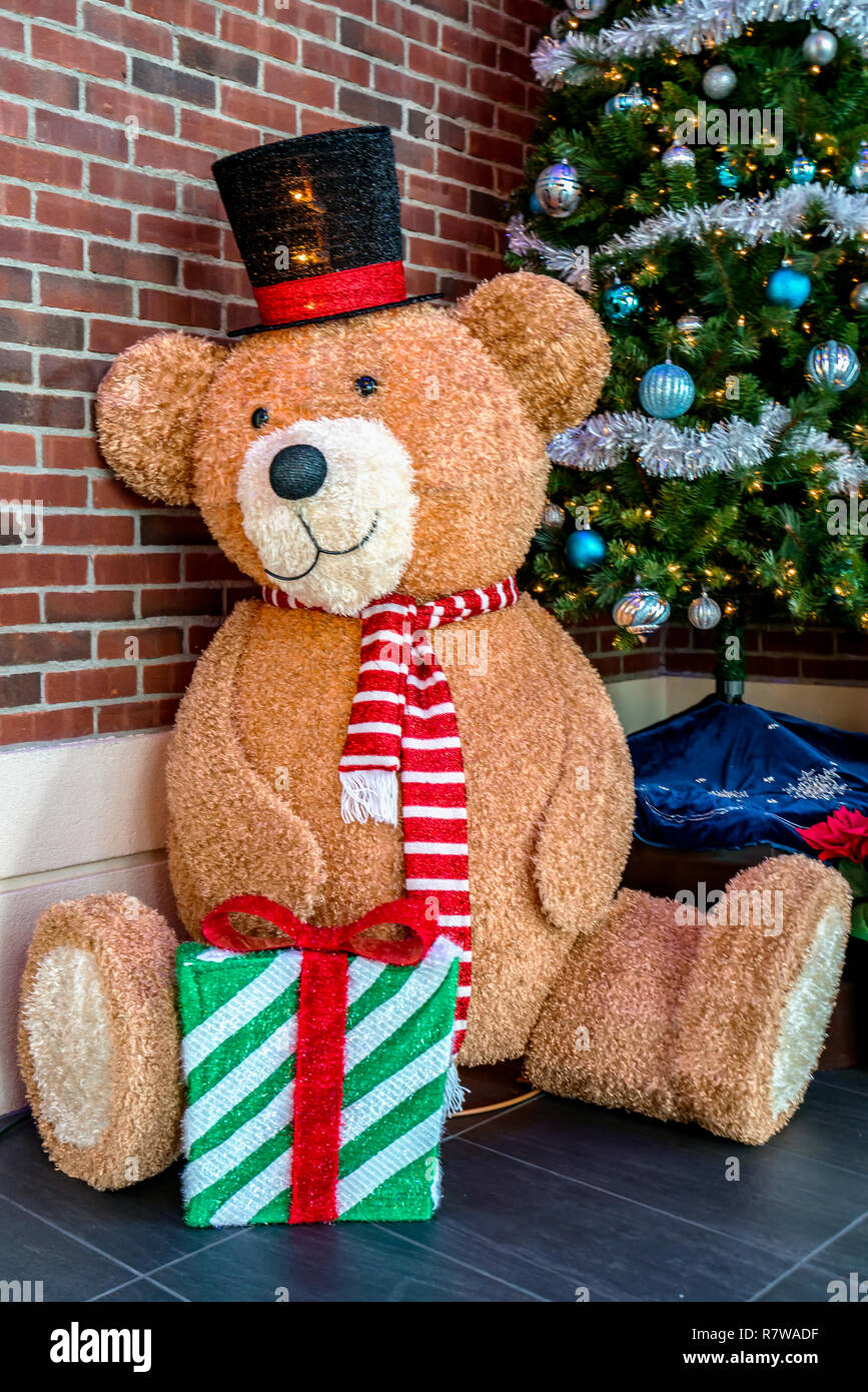 Si tratta di dicembre, tempo di Natale - colorata grande fantoccio giocattolo bambola orsacchiotto con dono Foto Stock