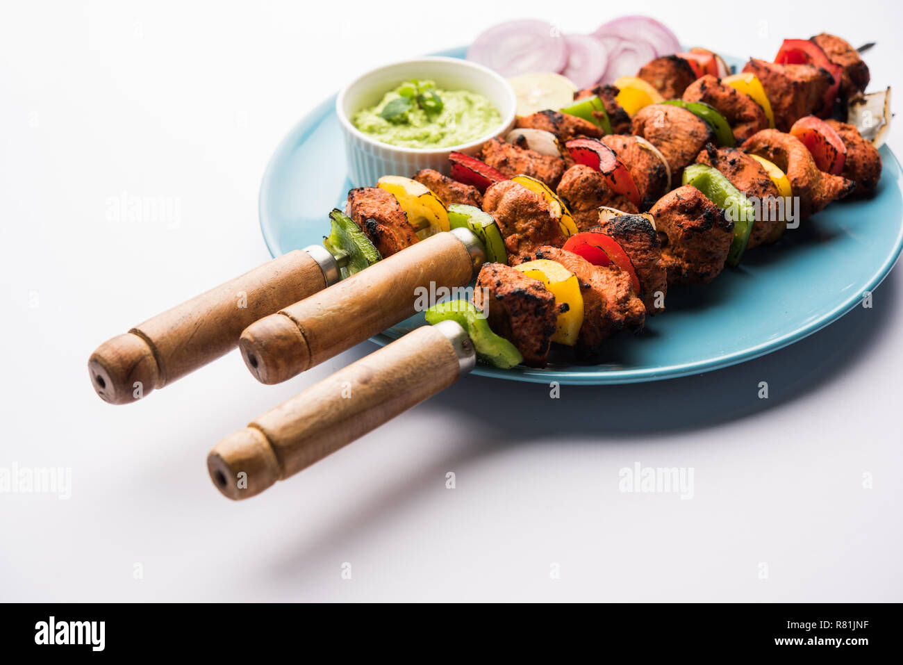 Pollo Tikka /Kebab sghemba. Tradizionale piatto indiano cucinati sul carbone e fiamma, condito & colorfully guarnita. servita con chutney di verde e insalata mista Foto Stock