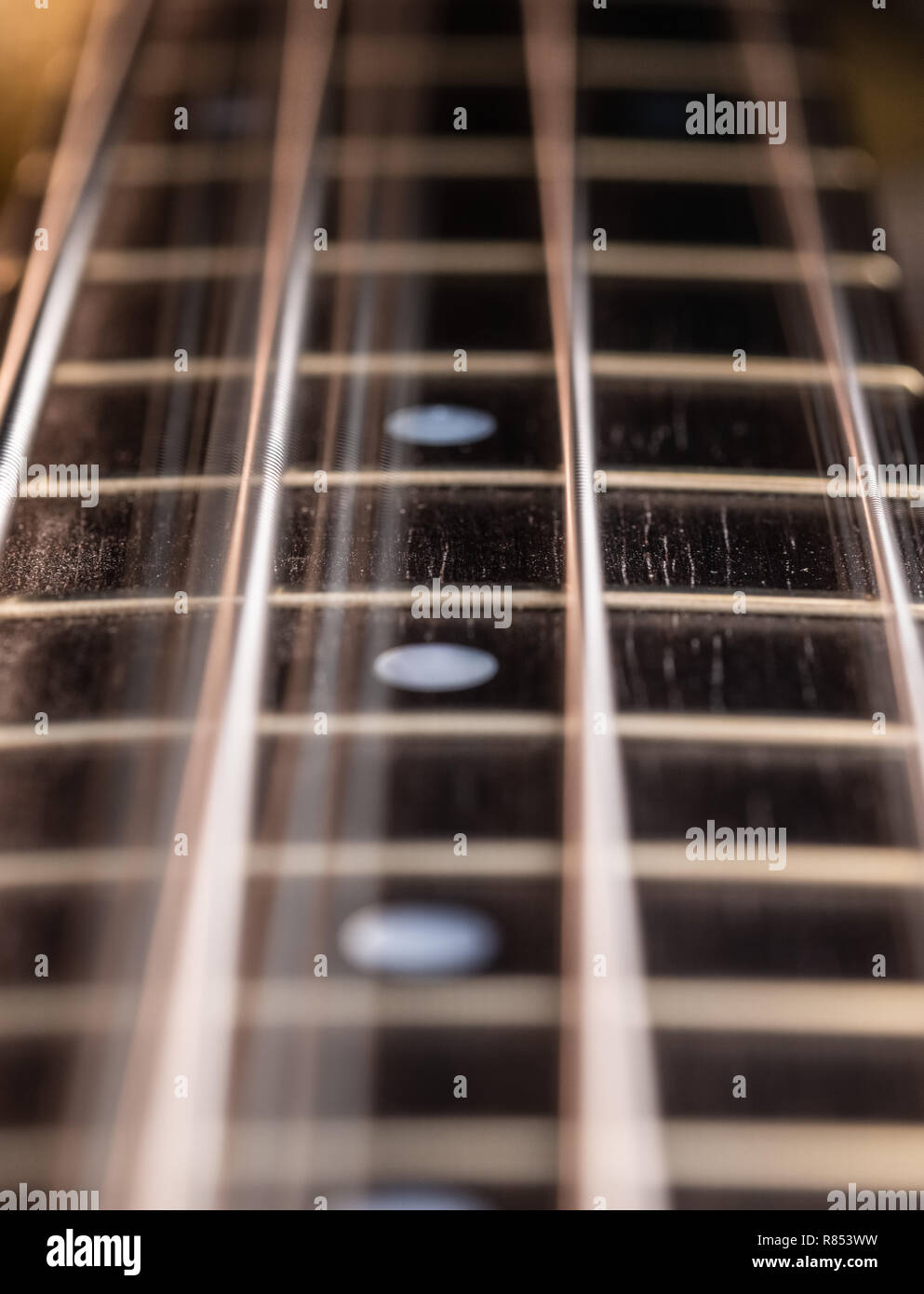 Close up di un bass guitar string e tastiera con vibrante stringhe Foto Stock