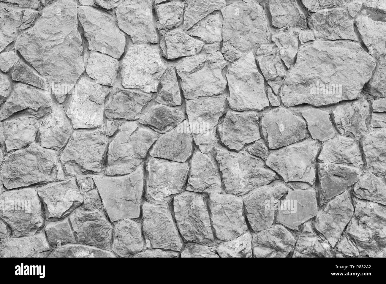 Grigio a muro di pietra texture. Naturale antica strada acciottolata come sfondo. Foto Stock