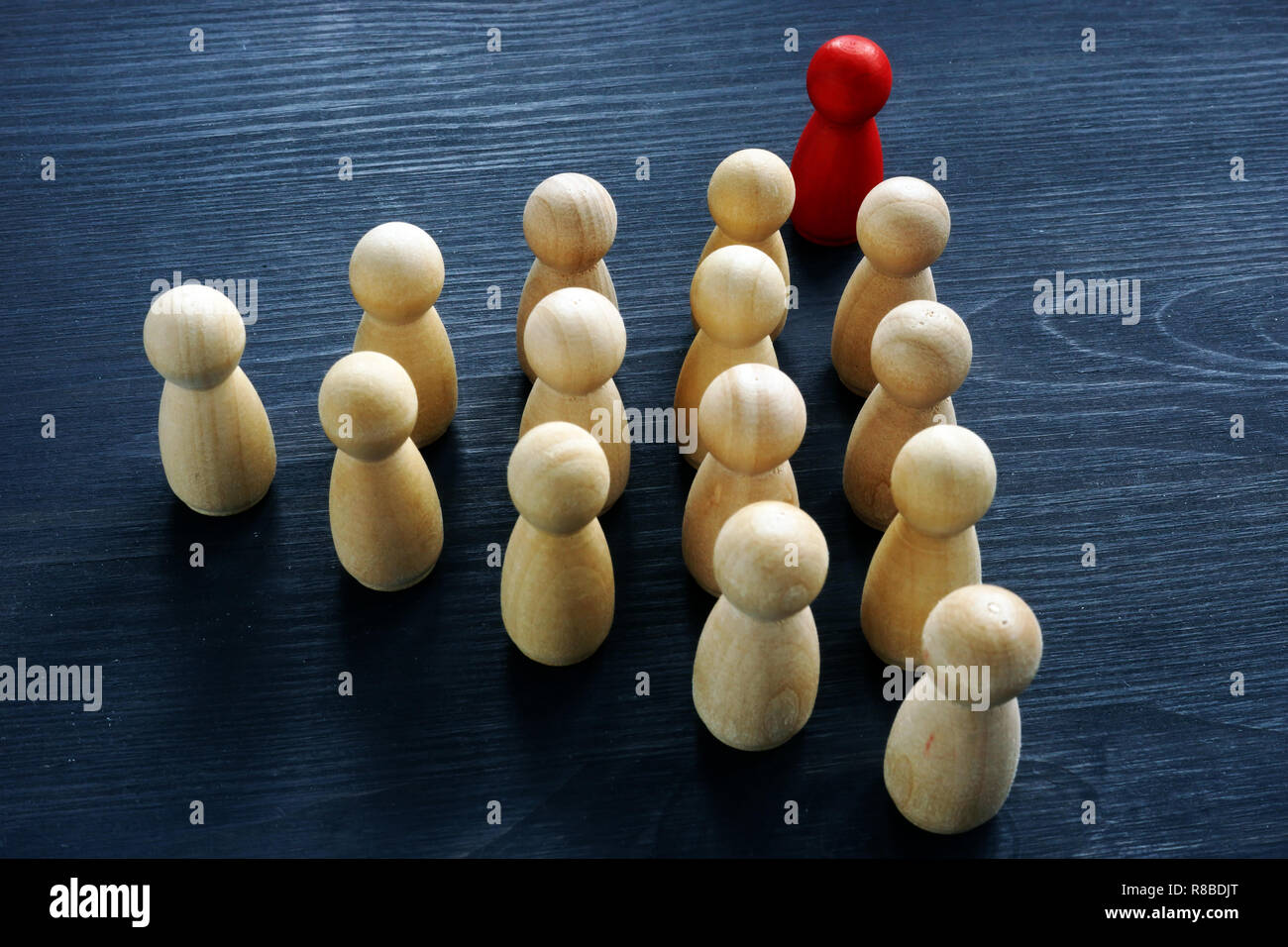 Il lavoro di gruppo in azienda e concetto di leadership. Figure in legno sulla scrivania. Foto Stock