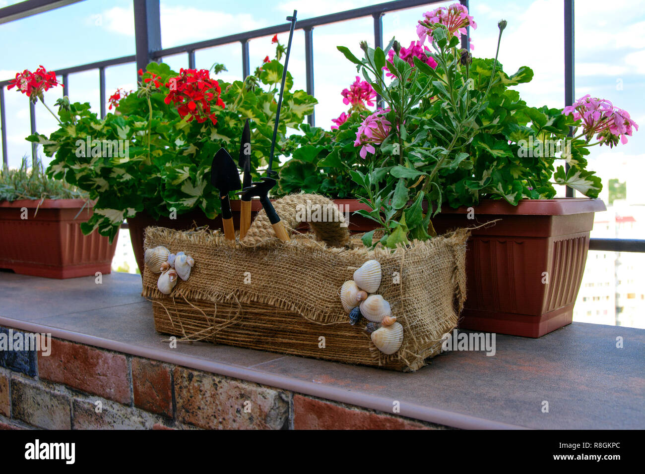 Bella, originariamente balcone decorato, con fatti in casa artigianale di vasi per fiori. Pieno di fiori, pentole, altro ornamento. Rosa, verde, bianco. Esempio di progettazione Foto Stock