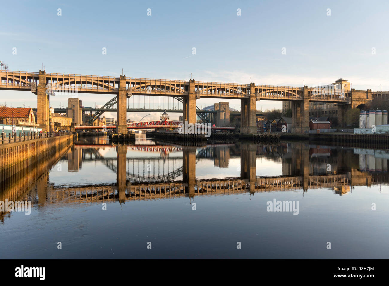 Il livello alto ponte e Tyne Bridge si riflette nel fiume, Newcastle upon Tyne, England, Regno Unito Foto Stock