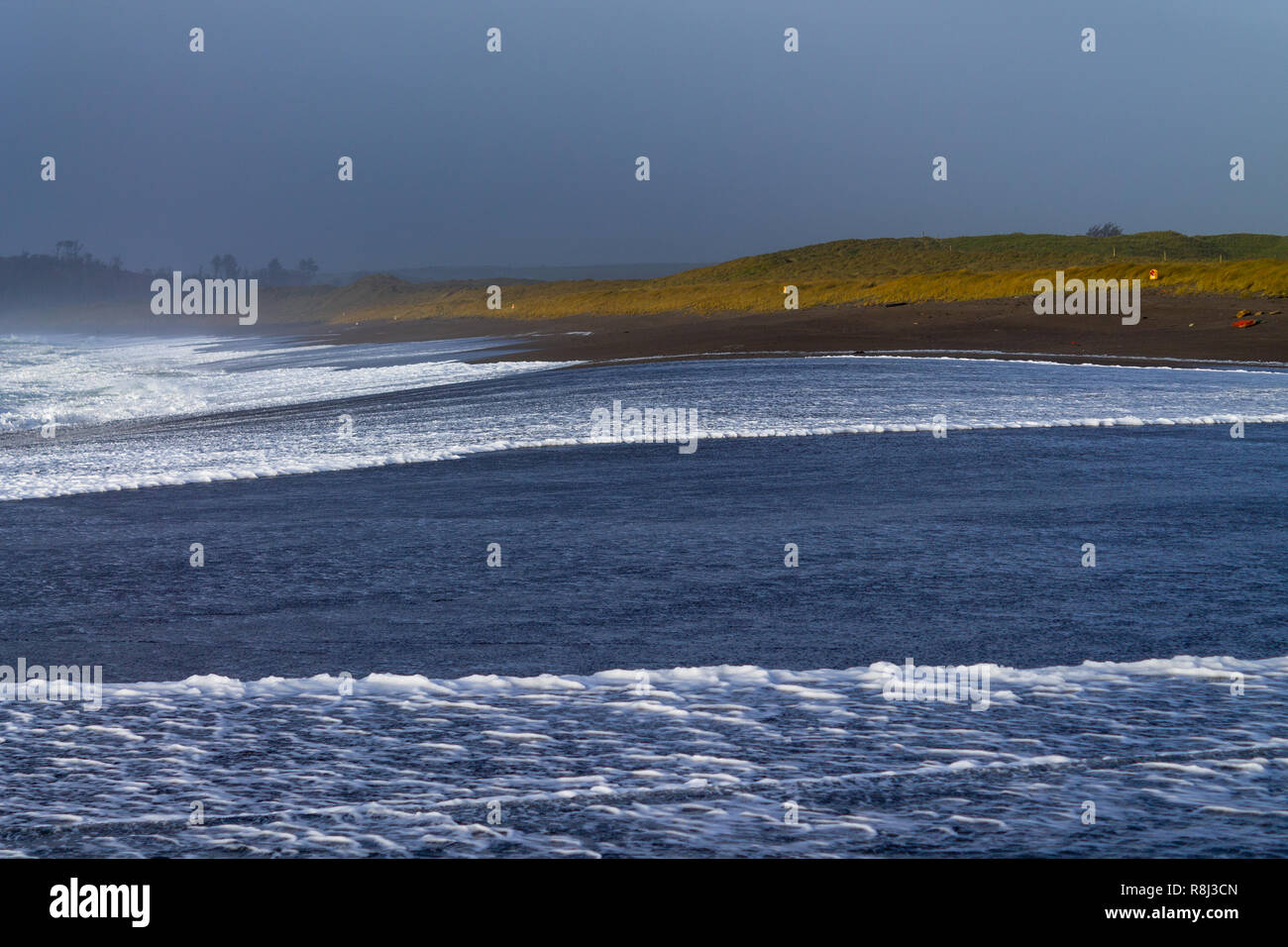 La laminazione delle onde sulla spiaggia o litorale Foto Stock
