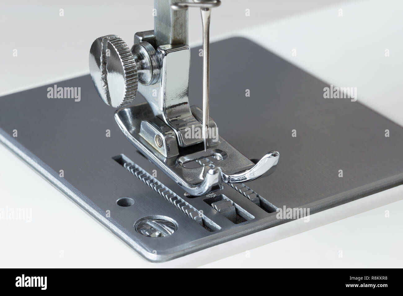 Parte di una macchina da cucire con un ago, la scheda e il rack di close-up Foto Stock