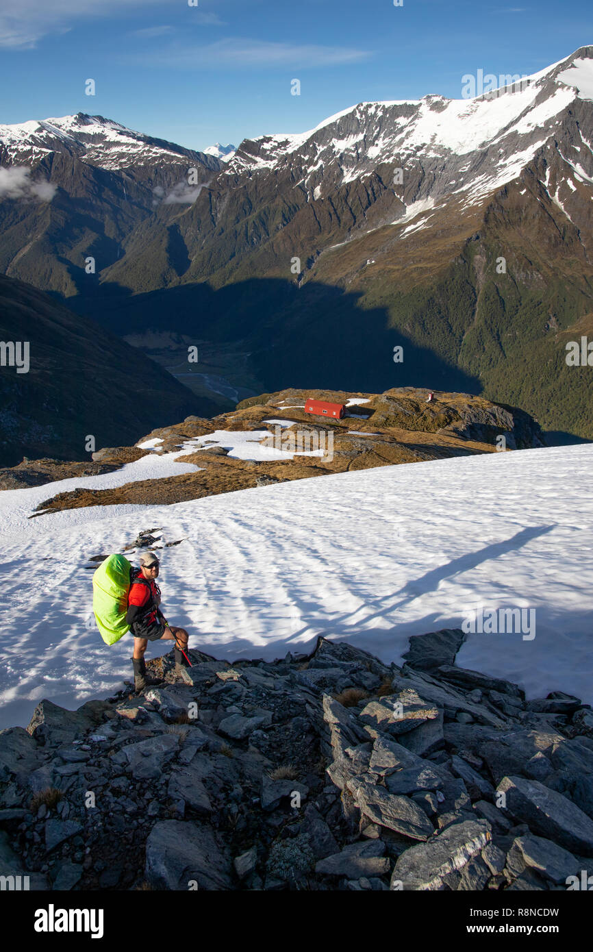 Escursionista nella neve sopra cresta francese capanna, Mt Aspiring National Park, Nuova Zelanda Foto Stock