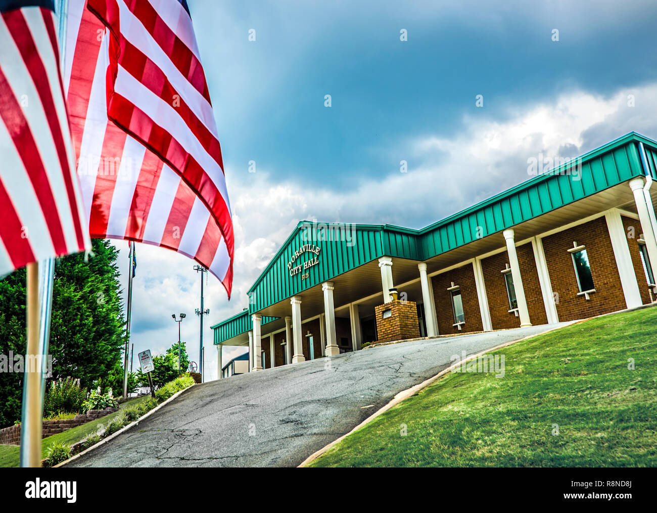 Bandierine americane ondata di fronte Doraville City Hall in Doraville, Georgia, 28 maggio 2014. La città fu incorporata nel 1871 per soddisfare le esigenze di fa Foto Stock
