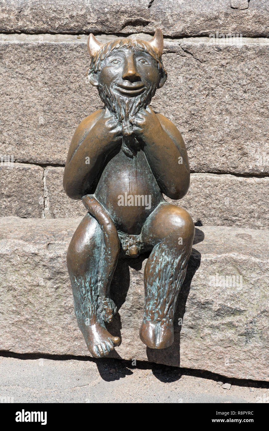 Metallo piccolo diavolo seduto su un gradino di pietra di fronte alla Marienkirche (St. Chiesa di Marys) a Lubecca, Germania Foto Stock