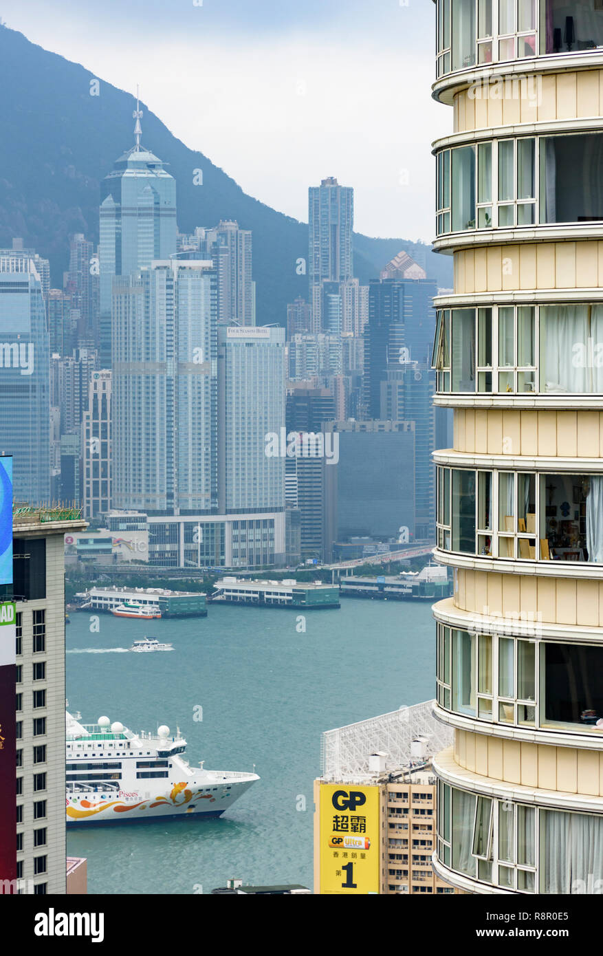 Una nave da crociera passa attraverso edifici alti con vedute di Isola di Hong Kong, da Tsim Sha Tsui, Kowloon Hong Kong Foto Stock
