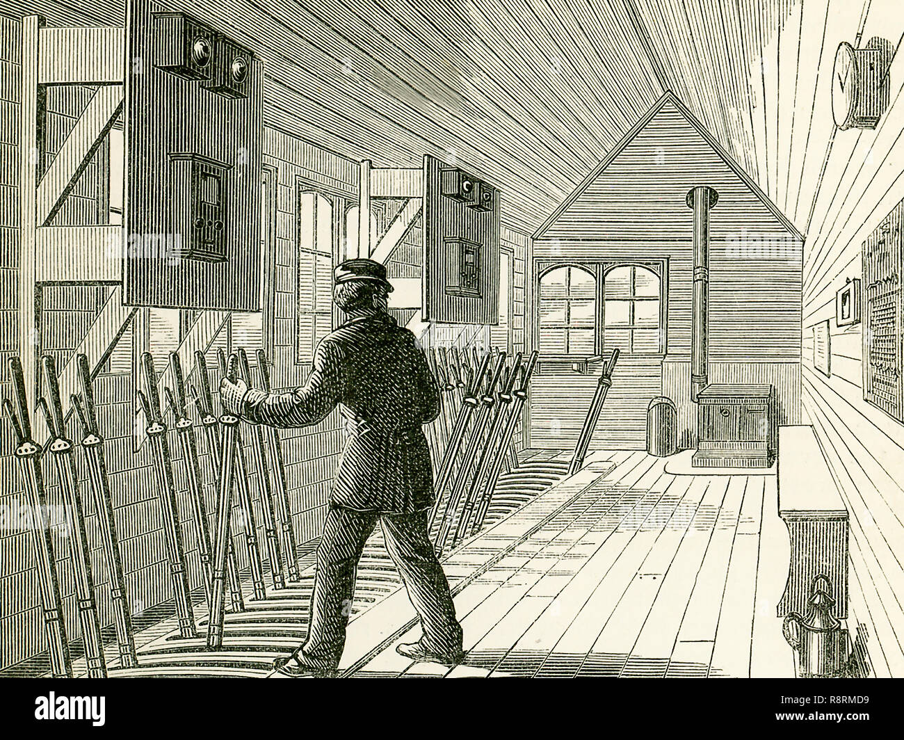 Questa illustrazione risale al 1870 e mostra la casella segnale sulla North London Railway. L'interno di un segnale-box in prossimità di un importante incrocio o stazione è mostrato qui e possiamo vedere qui le numerose leve per lavorare i punti e i segnali, ciascuno di questi avente un collegamento, da tondini o fili con il corrispondente punto o segnale-post. Il telegrafo elettrico è ora un importante agente di segnalamento ferroviario, e in un segnale-box si possono vedere le campane e strumenti che informa il pointsman se un certo tratto di linea è "bloccato" o "Cancella". I segnali ora generalmente utilizzato su Foto Stock