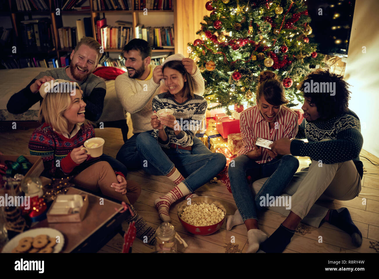 Gruppo di amici felici con doni ad una festa di Natale Foto Stock
