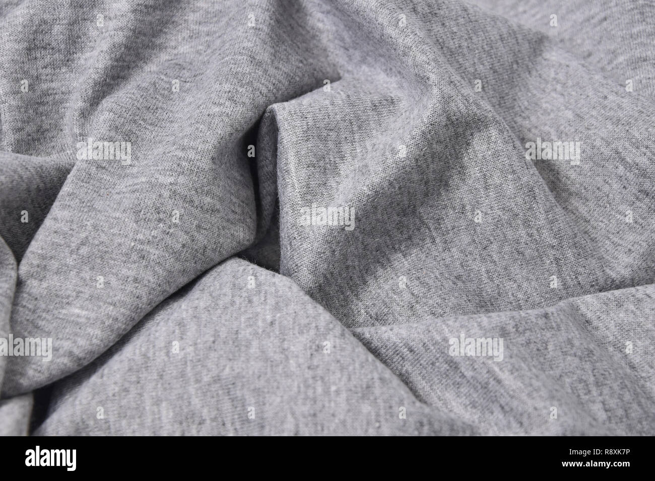 Close-up grigio t-shirt in cotone sfondo piega Foto Stock