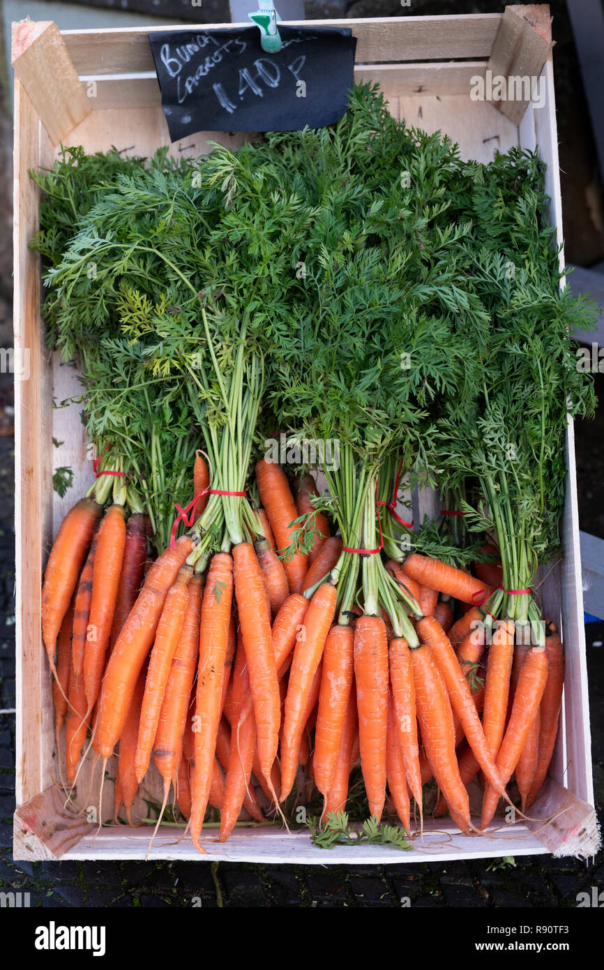 Coltivati localmente le carote al di fuori il Deli shop in dicembre. Deddington, Cotswolds, Oxfordshire, Inghilterra Foto Stock