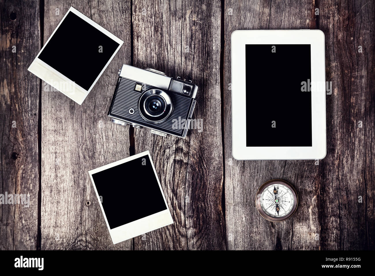 Vecchia telecamera cinematografica, tablet e foto con spazio per le immagini sullo sfondo di legno Foto Stock