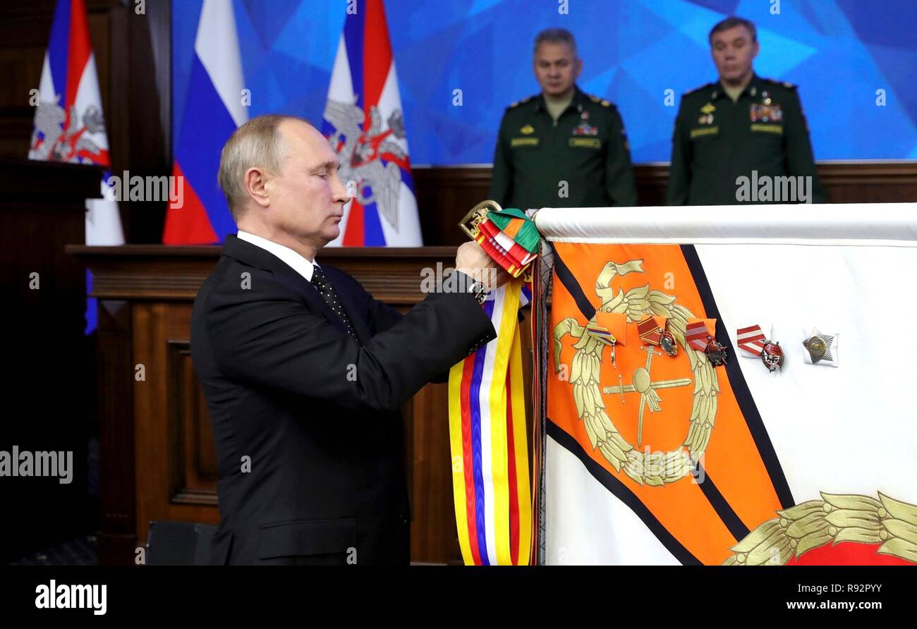 Mosca, Russia. Xviii Dicembre, 2018. Il presidente russo Vladimir Putin perni una bandiera del reggimento durante una cerimonia prima di un incontro con la leadership militare al ministero della Difesa russo sede Dicembre 18, 2018 a Mosca, in Russia. Credito: Planetpix/Alamy Live News Foto Stock