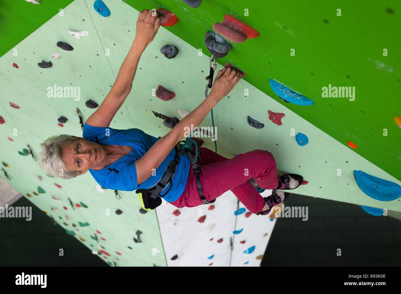 Arrampicata, donna si arrampica escalation artificiale facility, sporgenza, Germania Foto Stock