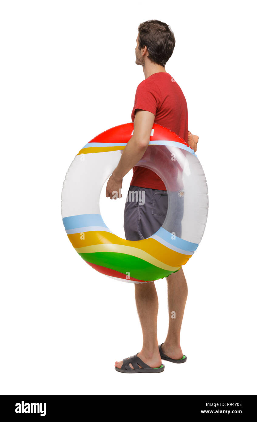 Vista posteriore di un uomo in pantaloncini corti con un cerchio gonfiabile. Il ragazzo sulla spiaggia. Vista posteriore di raccolta persone. vista posteriore di persona. Isolate su wh Foto Stock
