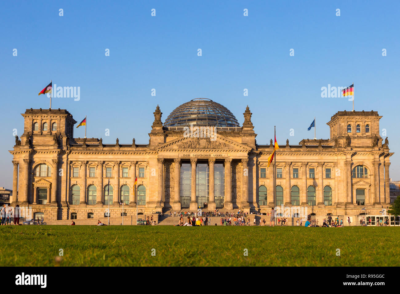Berlino, Germania - Apr 28, 2018: persone rilassarsi sul prato di fronte al Reichstag, sede del Parlamento tedesco (Deutscher Bundestag). Foto Stock