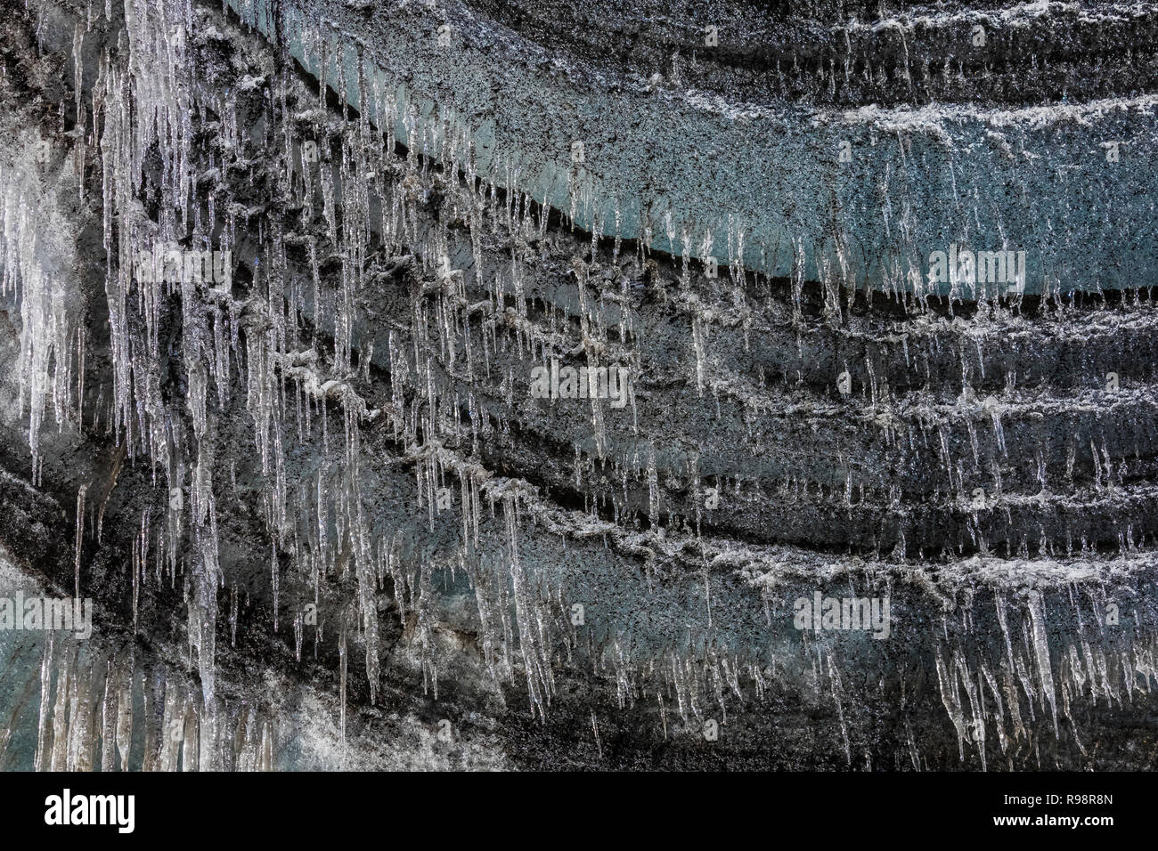 Ghiaccioli all'entrata di una caverna di ghiaccio nella parte terminale di un lobo del ghiacciaio Mýrdalsjökull, che siede in cima al vulcano Katla, in inverno in Islanda Foto Stock