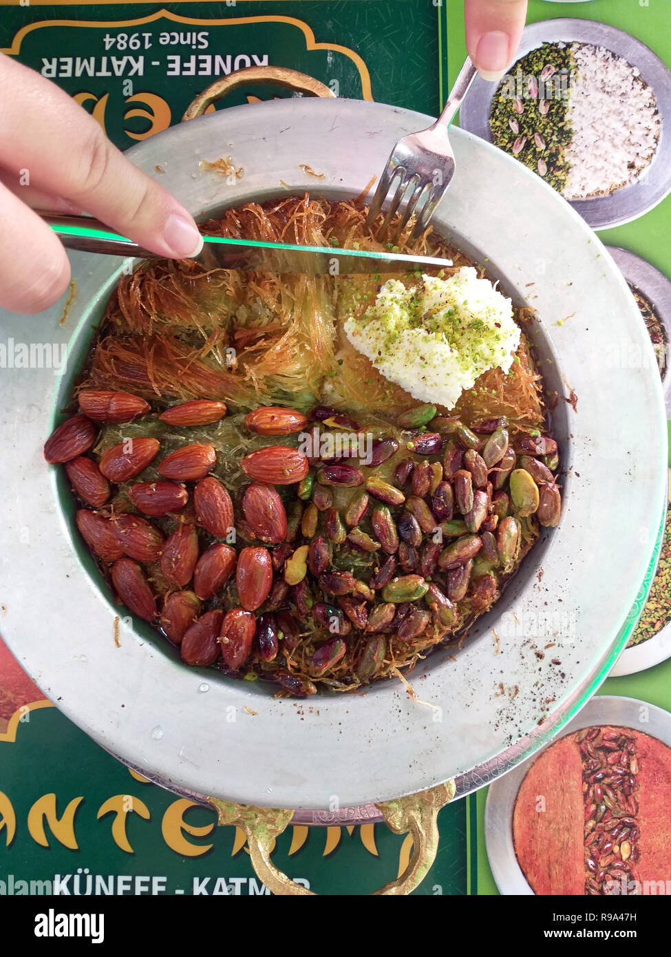 Dolce turco kunefe, kunafa, kadayif con polvere di pistacchi e formaggio hot mangiato un dolce Foto Stock