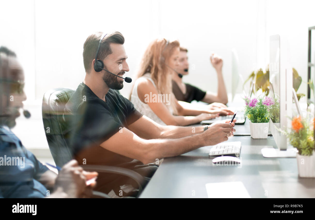 Il personale del call center seduto alla scrivania. Foto Stock